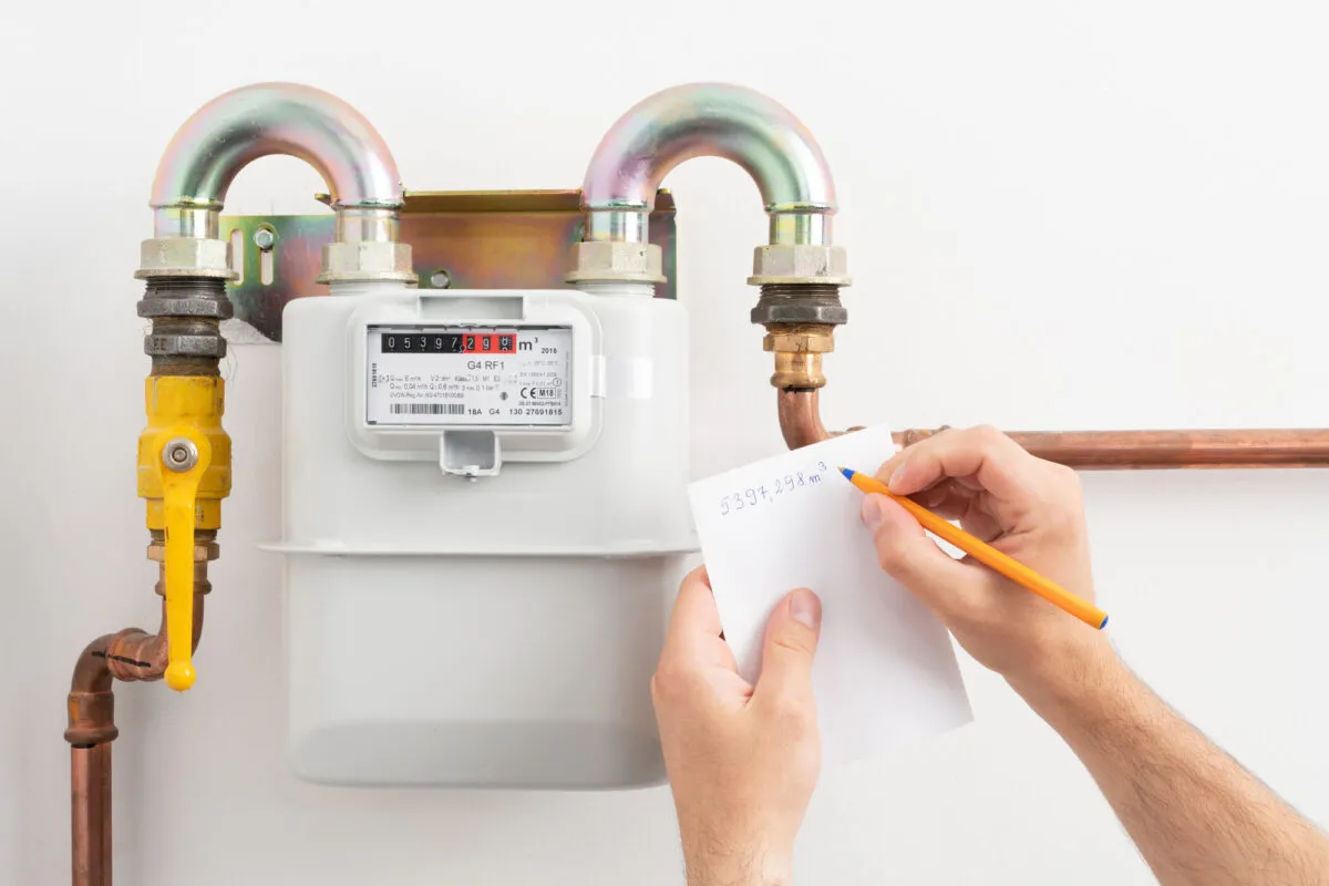 Young man reading the gas meter in the private house counter, Depositphotos