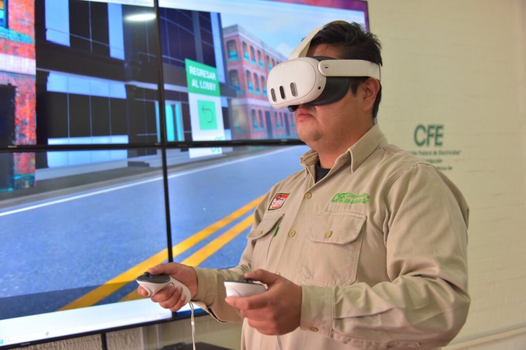 1778797164318 - Petróleo y Energía Man wearing a white VR headset and holding game controllers, standing in front of a large screen display showing a street scene, likely in a training demo.