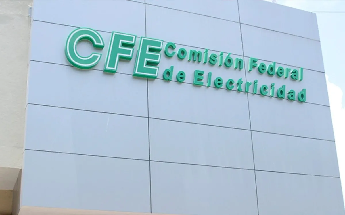 Green CFE sign reading 'Comisión Federal de Electricidad' on a blue-gray tiled building facade
