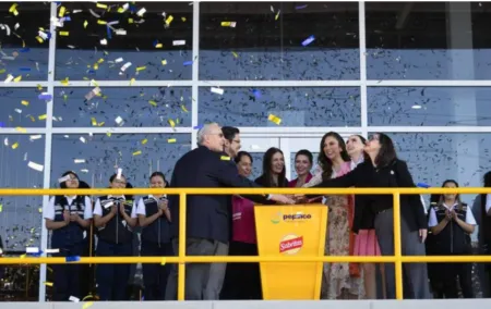 Group of people celebrate a grand opening on a balcony, confetti raining down and a yellow podium with Sabritas and PepsiCo branding visible in the foreground.