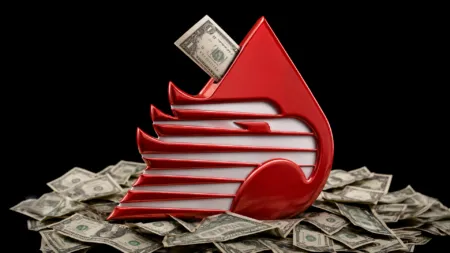 Red abstract swoosh sculpture with a dollar bill tucked into its opening, surrounded by scattered cash on a black background.