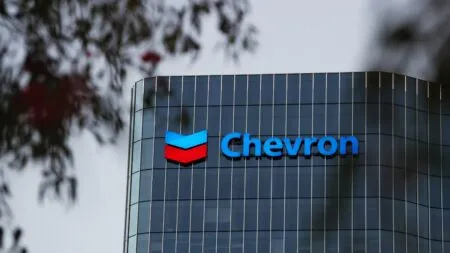 Chevron logo displayed on a curved glass office building facade