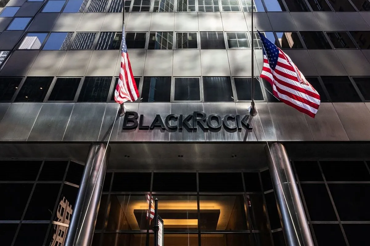 Facade of a modern glass building with the BlackRock logo and two American flags above the entrance.