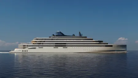 Large white luxury yacht with multiple decks sailing on calm blue sea under a clear sky.
