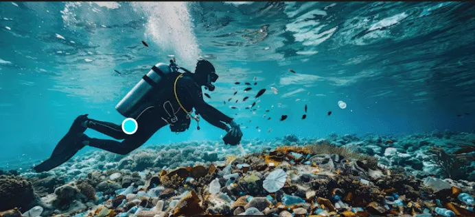 Scuba diver in a black wetsuit glides above a colorful coral reef underwater.
