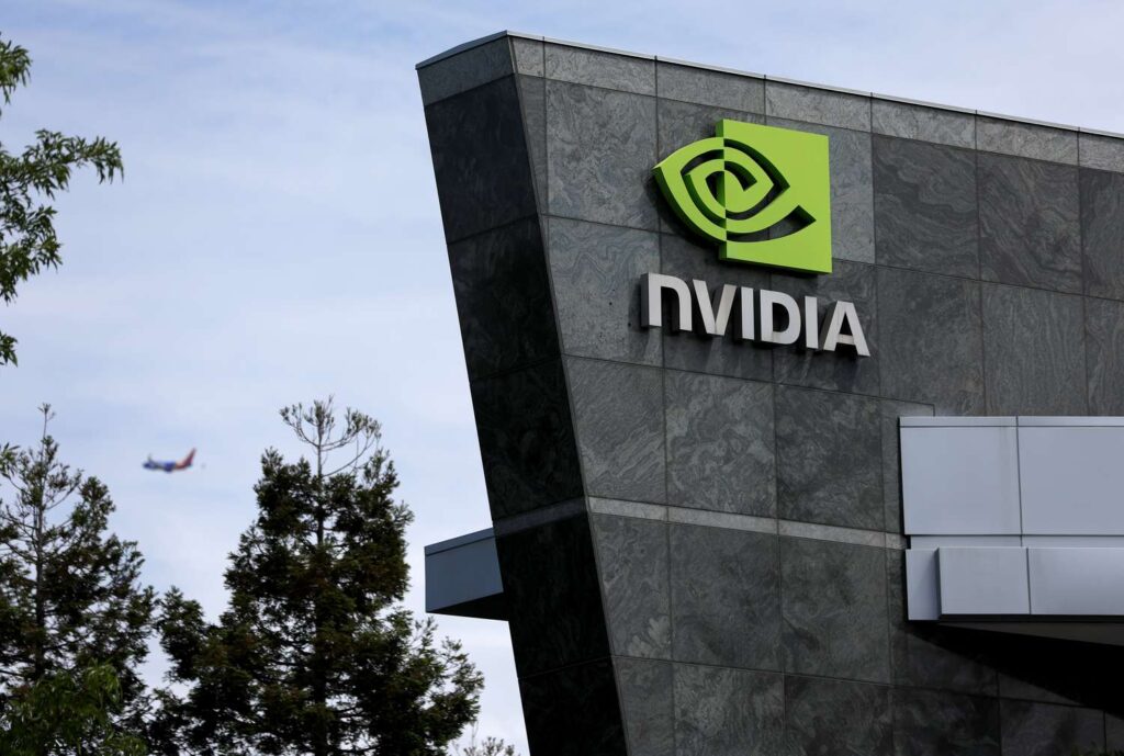 NVIDIA logo on a dark gray stone building exterior with trees and a distant airplane in the sky.