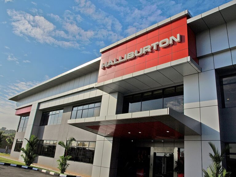 Modern office building with a red Halliburton sign on the facade against a blue sky Societal image?