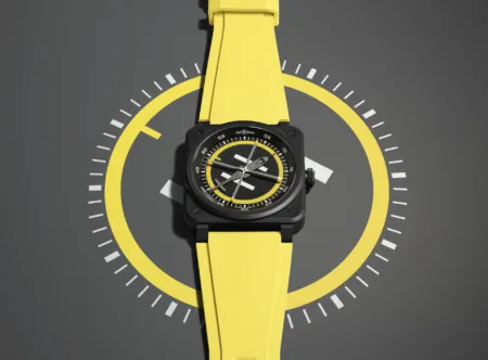 Yellow-strapped Bell & Ross wristwatch with a black square case and a circular, multi-layered dial against a dark background.