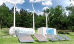 Hydrogen energy site with wind turbines, solar panels, and a storage tank labeled HYDROGEN H2 in a green field.