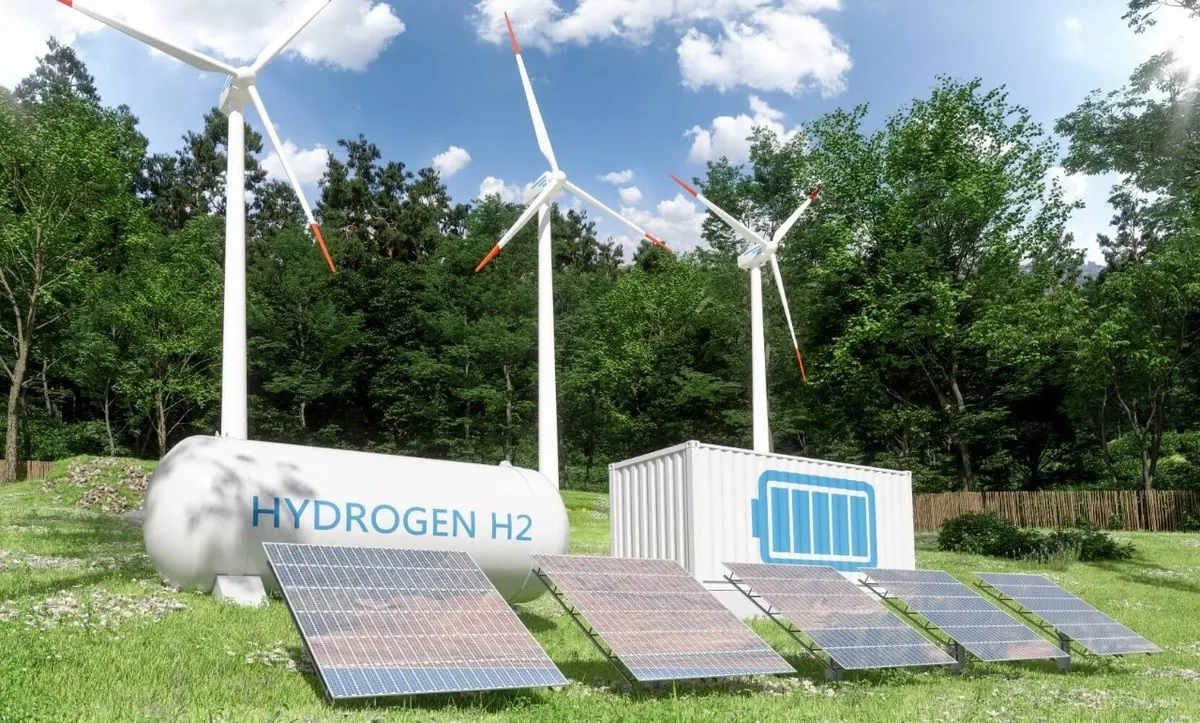 Hydrogen energy site with wind turbines, solar panels, and a storage tank labeled HYDROGEN H2 in a green field.