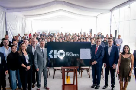 Large group of professionals posing for a group photo behind a sign that reads 'Data Centers' in a bright indoor venue.