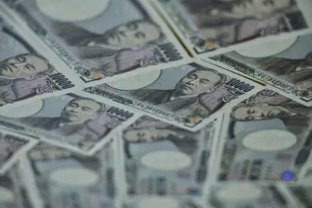 Several 10,000 yen banknotes featuring Fukuzawa Yukichi fanned out.