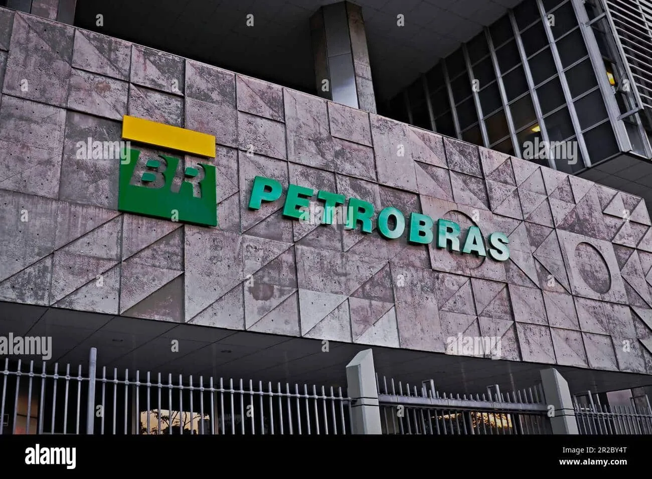 Exterior of a Petrobras building with the BR PETROBRAS sign on a mottled stone wall and a yellow bar logo above it