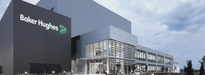 Exterior view of a modern Baker Hughes office building with the company logo on a dark tower site signage visible.