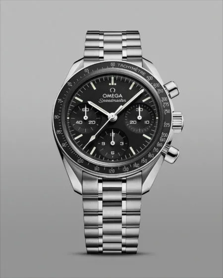 Close-up of an Omega Speedmaster stainless steel watch with a black dial, three subdials, and a tachymeter bezel.