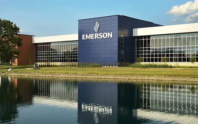 Emerson headquarters: modern blue central tower with logo, flanked by glass-front office wings beside a reflecting pond