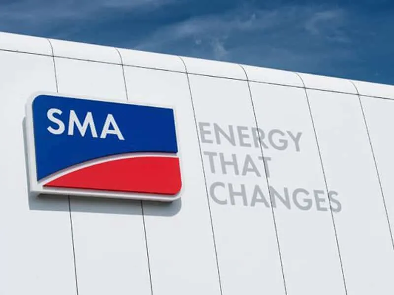 SMA logo on a white building with the slogan 'Energy That Changes' in light gray text nearby.