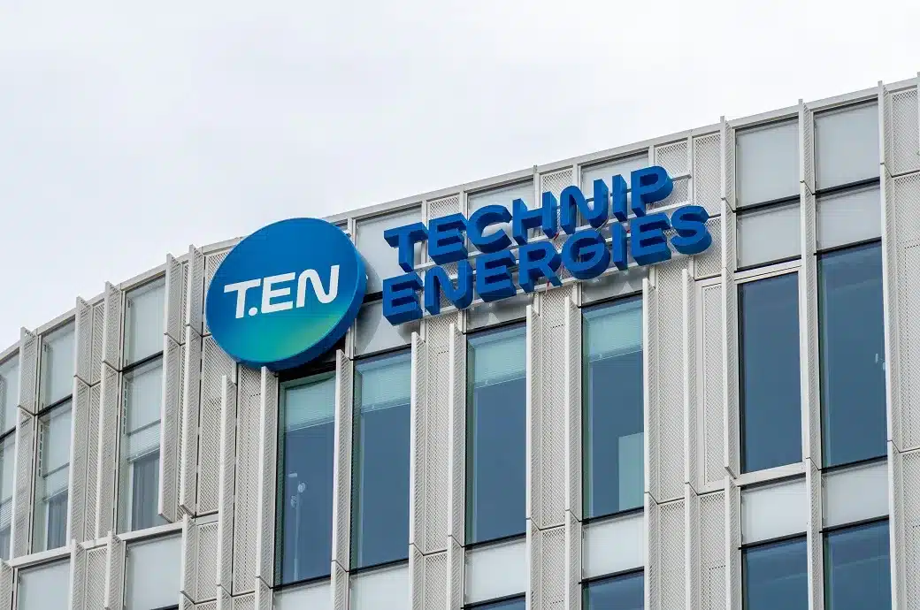 Building façade with a blue circular TEN logo and the words TECHNIP ENERGIES above a glass-fronted office building
