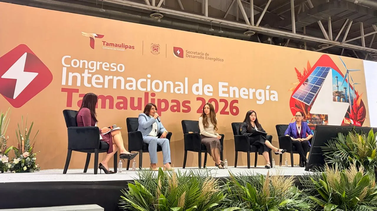 Panel discussion on stage at the International Energy Congress Tamaulipas 2026, five speakers seated in black chairs with a large orange backdrop behind them.