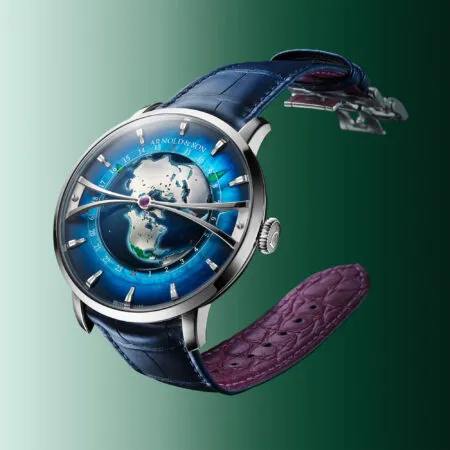Close-up of a blue-dial wristwatch with a world-map motif and a blue leather strap.