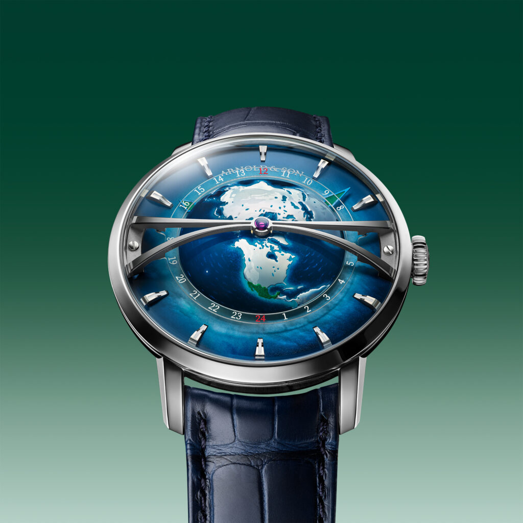 Stacked from 15 images Method=B R=8S=3 - Petróleo y Energía Close-up of a luxury wristwatch with a blue dial showing a world map, silver case, and dark blue leather strap against a green gradient background.