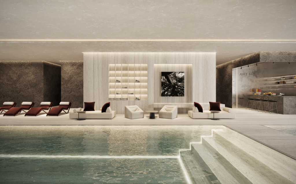 POOL_LAGERFERLD - Petróleo y Energía Luxurious indoor pool lounge with beige seating, loungers along the pool, and a juice bar on the right.