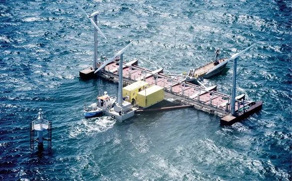 Floating offshore wind turbine installation platform with two turbine nacelles and a yellow equipment module in the open sea